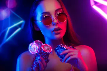 A woman smiling by bright slot machines showing lucky symbols, showcasing the exciting slot offerings at 456BD.